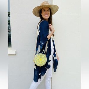 Caroline Hill round straw crossbody bag with pearl zipper detail